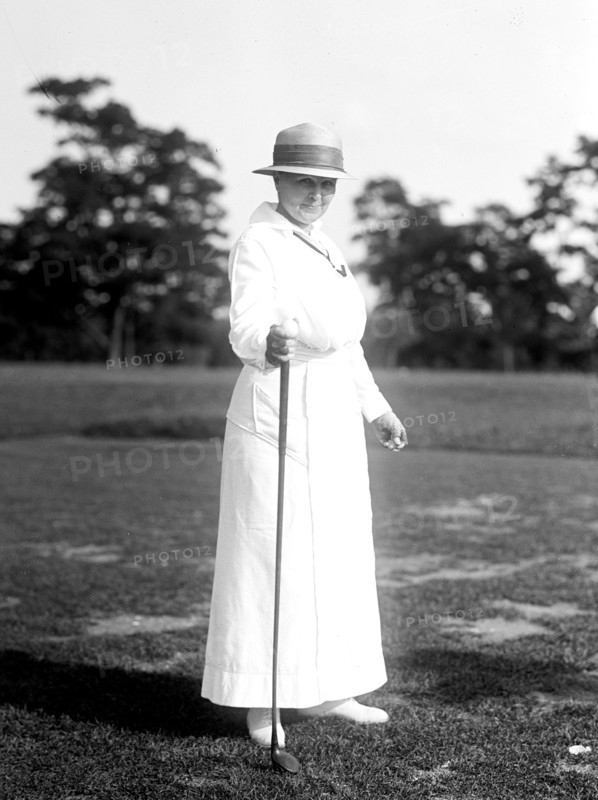 Woman holding golf club circa 1917.