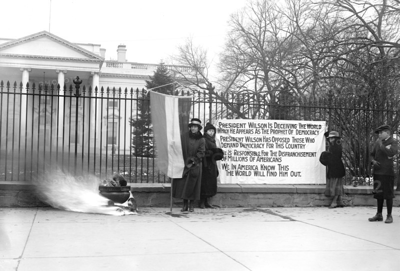 Woman Suffrage Movement - Bonfire on the sidewalk in front of the White House circa 1918 .