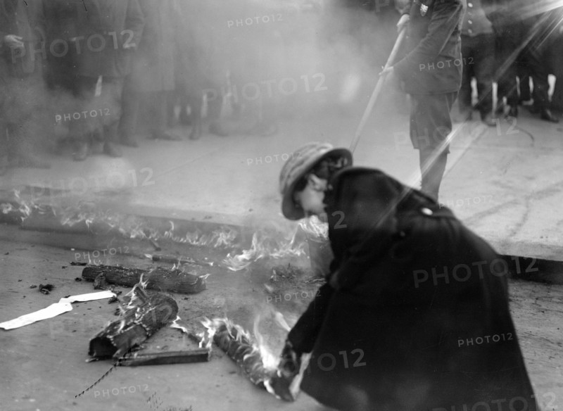 Woman Suffrage Movement - Bonfire on the sidewalk in front of the White House circa 1918 .