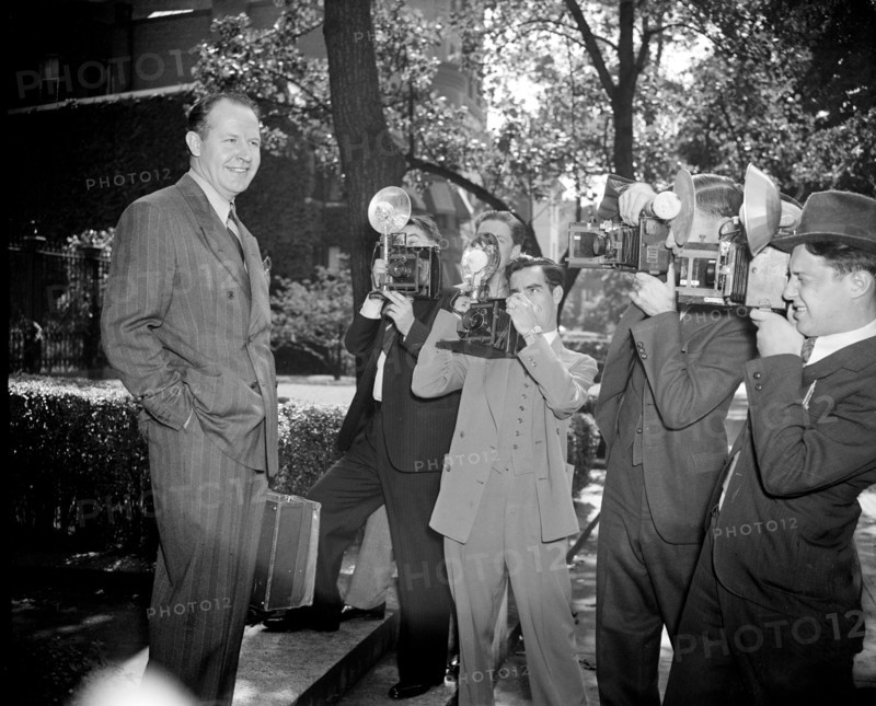 News photographers taking picture of Jimmy Mattern, noted flyer, leaving the Soviet Embassy today after reporting on his search for the six Russian Polar Flyers lost far above the Arctic Circle circa 1937.