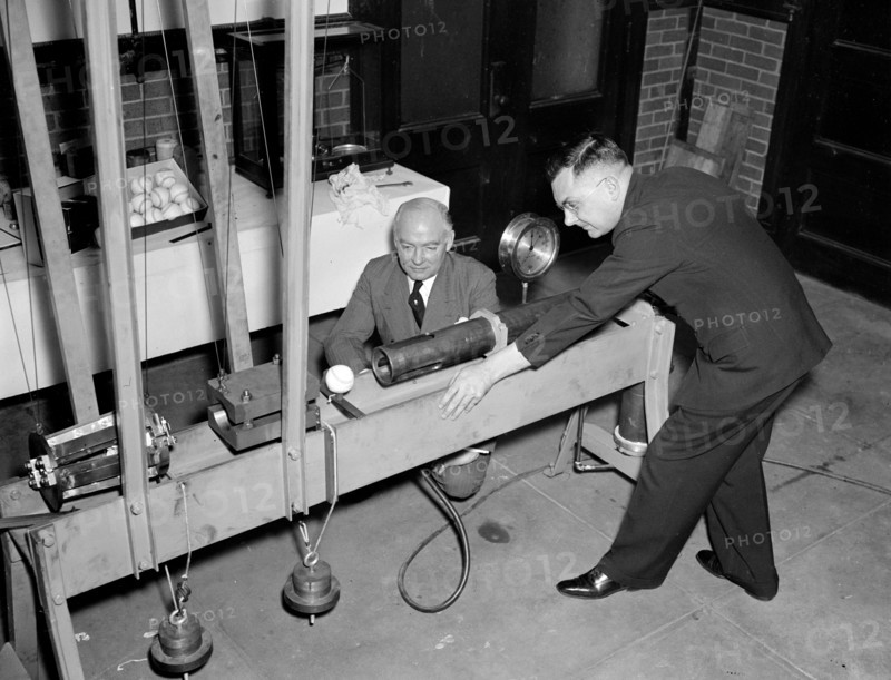 Government Waste - Bureau of Standards designs mechanical batter to determine liveliness of baseballs, an example of government wasting money during the Great Depression circa 1938 .