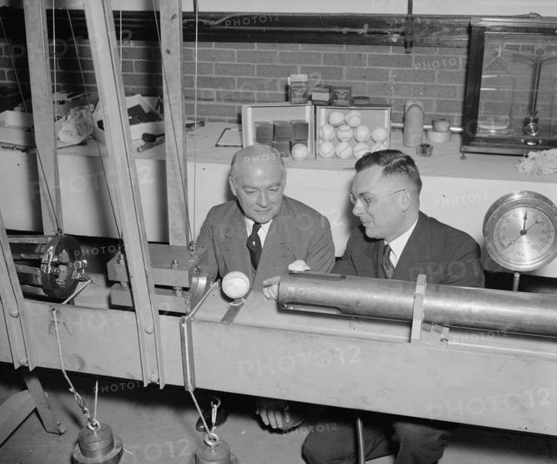 Government Waste - Bureau of Standards designs mechanical batter to determine liveliness of baseballs, an example of government wasting money during the Great Depression circa 1938 .
