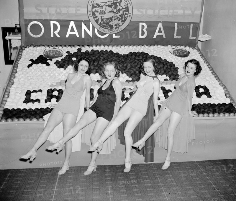 Women posing with California orange week festival ball display circa 1938.