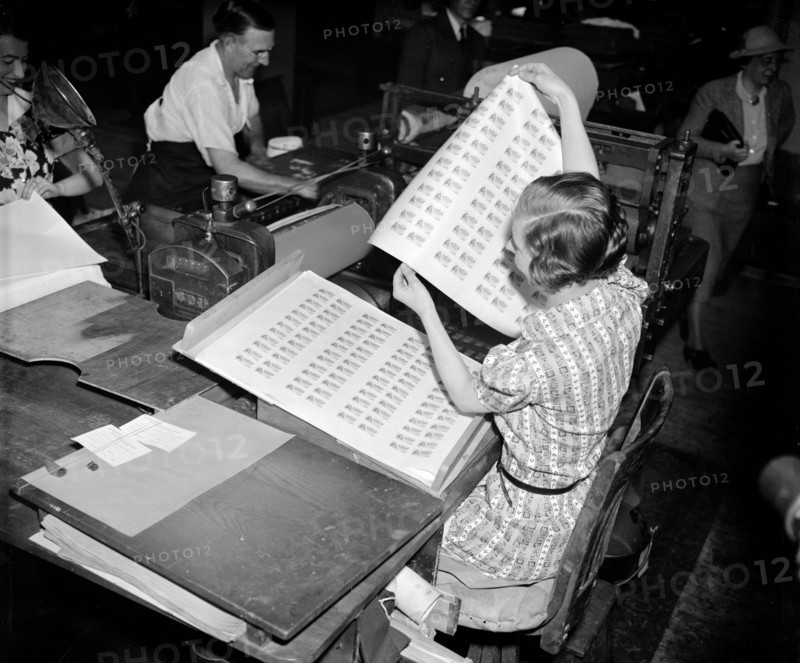 Imogene Stanhope, printer's assistant at the Bureau, is pictured pulling the first batch of U.S. government food stamps  off the press circa April 20, 1939.