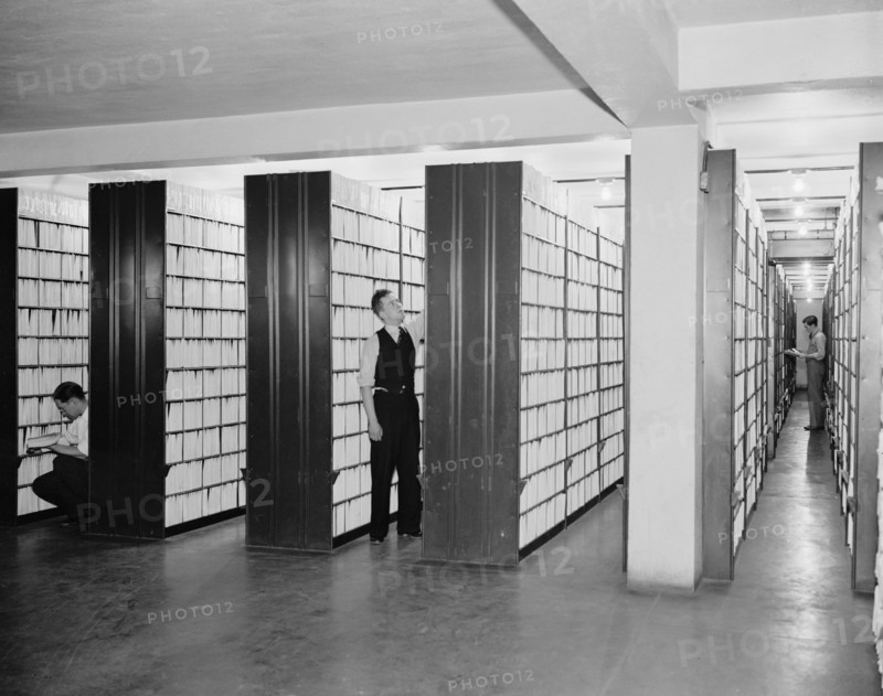 United States Patent office workers looking through collection of over 2,000,000  patents circa 1940 .