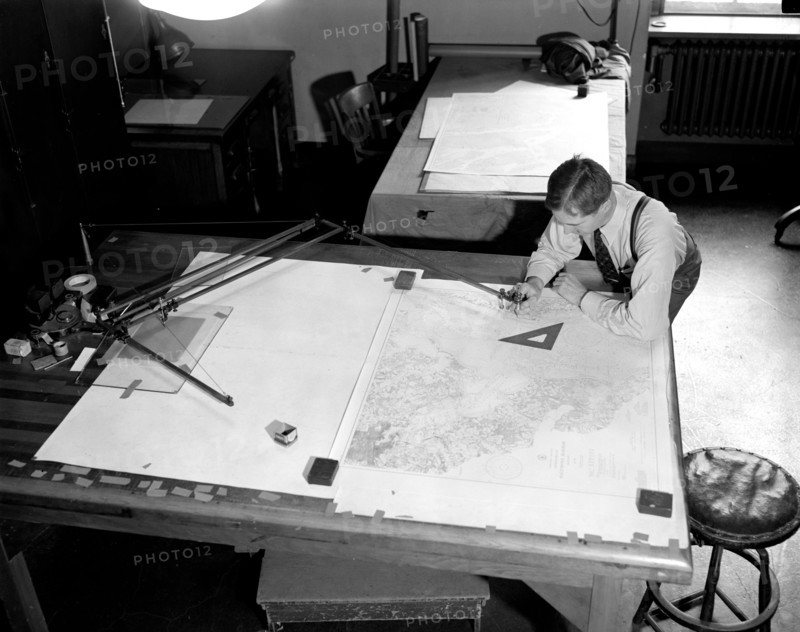 Map-making Division of Coast & Geodetic Survey, Dept of Commerce, cartographer in process of making a map circa 1940 .