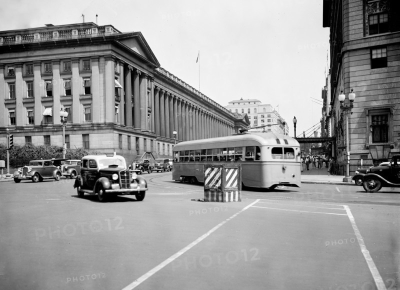 Cars and bus on Pennsylvania Avenue and 15th Street in Washington D.C. circa July 1936.