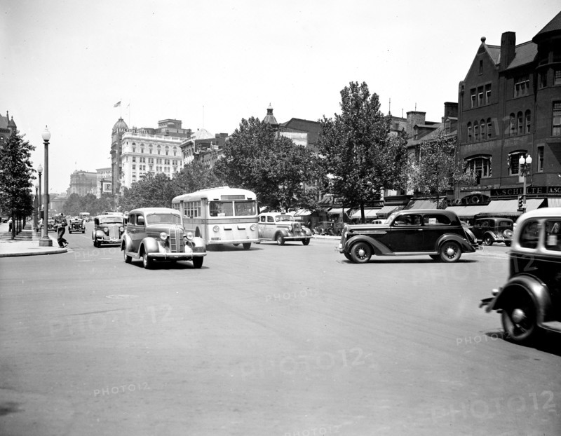 Bus and cars in Washington D.C. traffic street scene circa July 1936.
