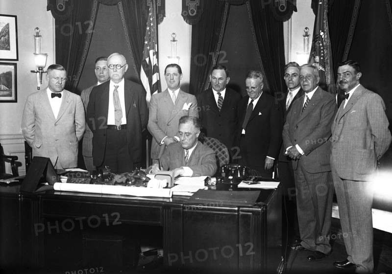 Franklin D. Roosevelt - President Roosevelt signs small home loan measure. President Roosevelt today signed the bill providing for a $2,000,000,000 refinancing of small home mortgages to put them on lower interest rates circa 1933.
