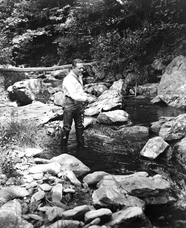 A man fishing in a river circa 1932.