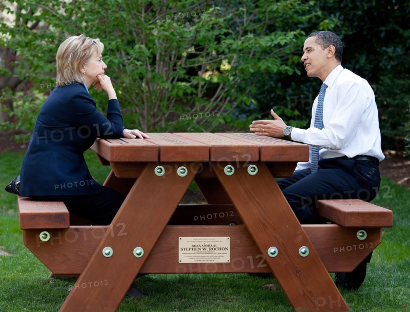 President Barack Obama and Secretary of State Hillary Rodham Clinton speak together sitting at a picnic table April 9, 2009, on the South Lawn of the White House. .