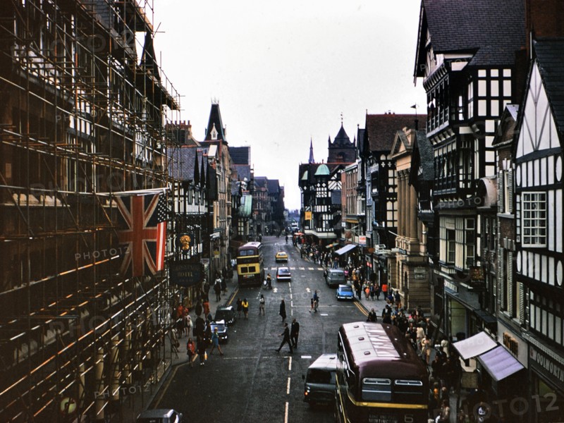 Buses and traffic on a street in Chester England circa July 1973.