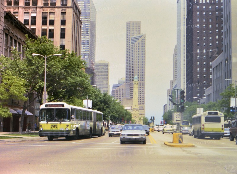 Cars and buses in busy downtown Chicago traffic circa 1985 .