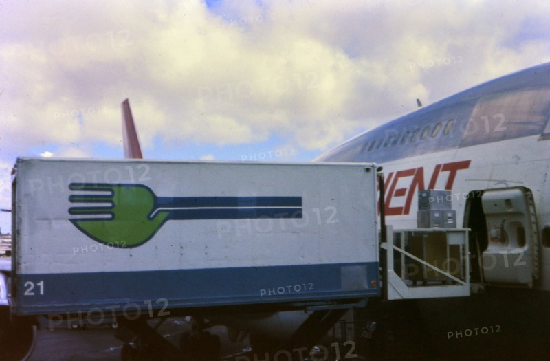 Skychef crew loading a Northwest Orient Airlines plane circa 1976.