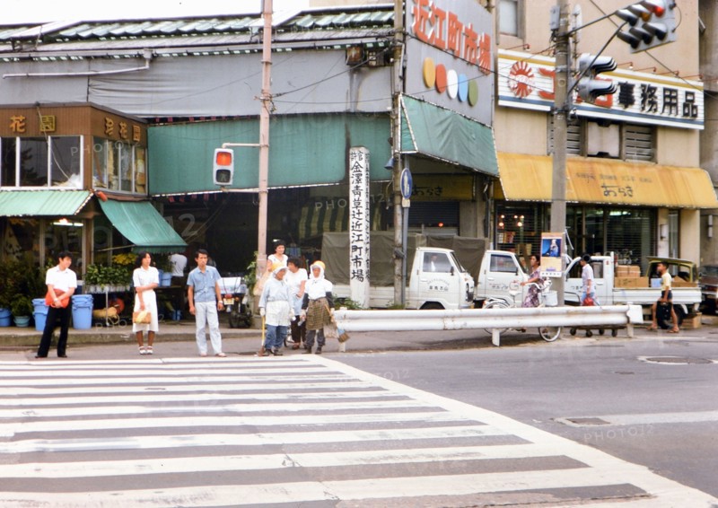 Lady street cleaners waiting at traffic crossing in Kanazawa Japan circa 1976.
