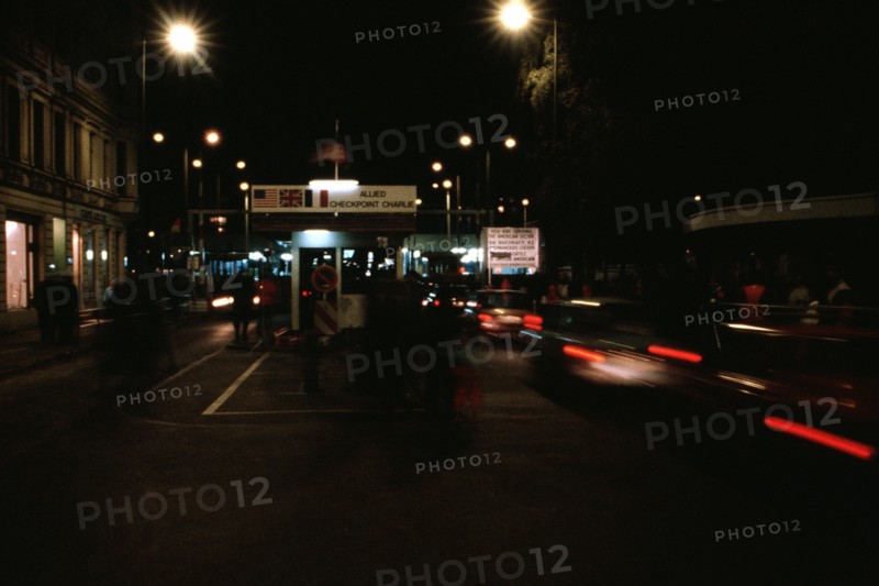 East Germans drive their vehicles through Checkpoint Charlie as they return to the East following a visit to the West..