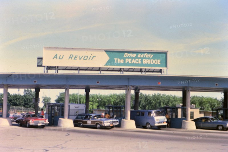 (R) New York 1975 - U.S. Canada border crossing - cars leaving the country circa 1975.