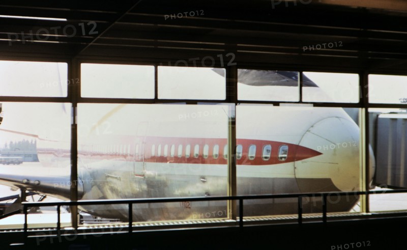 1972 France - (R) - Nose of a large airplane viewed through an airport terminal window circa 1972.