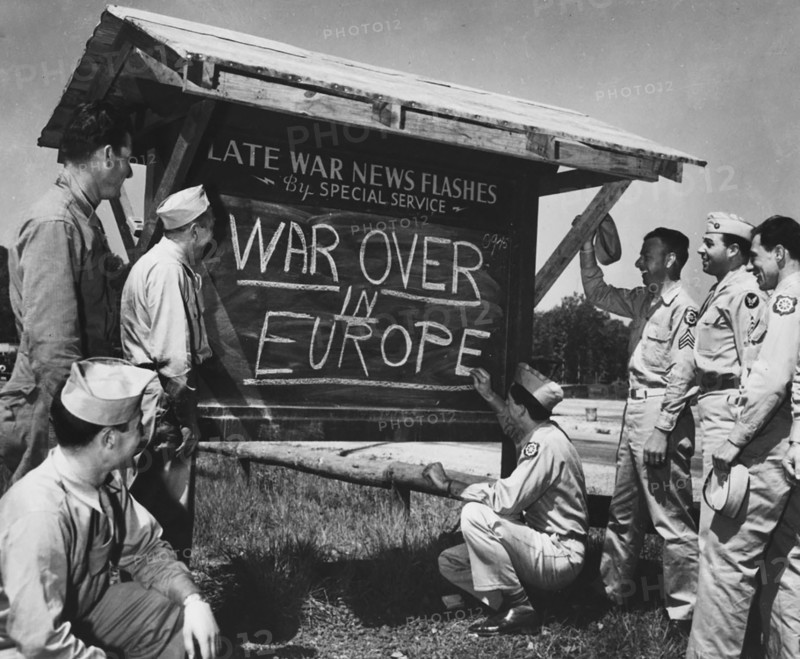 An Army private is shown breaking the news of the end of the war in Europe