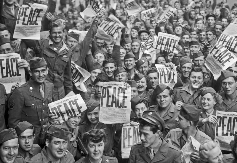 VE Day - Soldiers hold up the Stars and Stripes newspaper