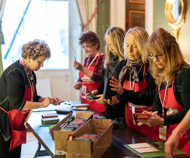 Volunteers prepare decorations for the Green Room of the White House Wednesday