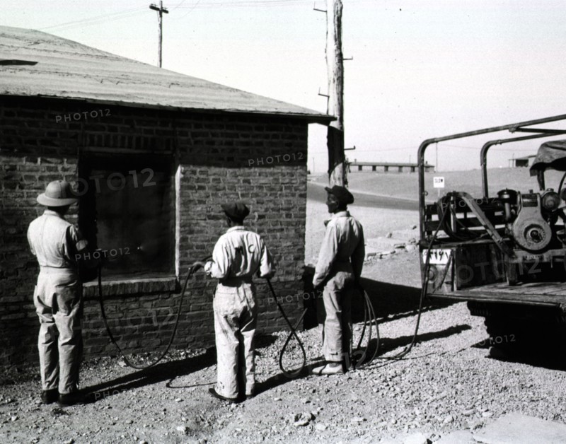 A malaria control detachment sprays billets at Amirabad Post