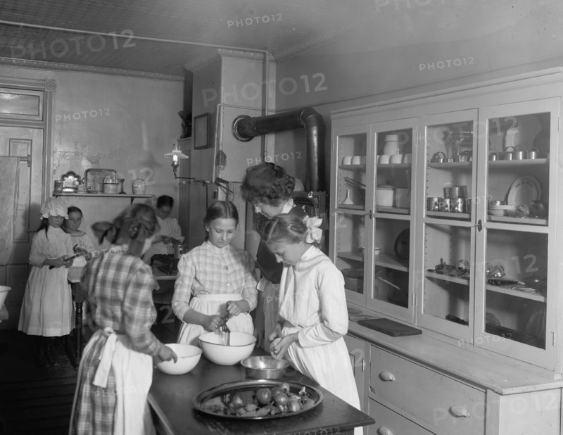 Women and girls working in a kitchen