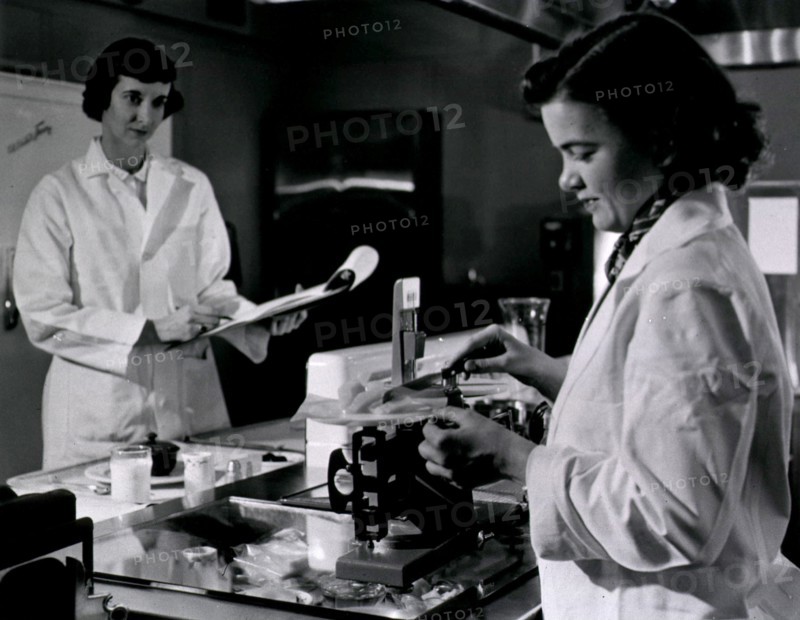 Two female dietitians weigh and measure foods