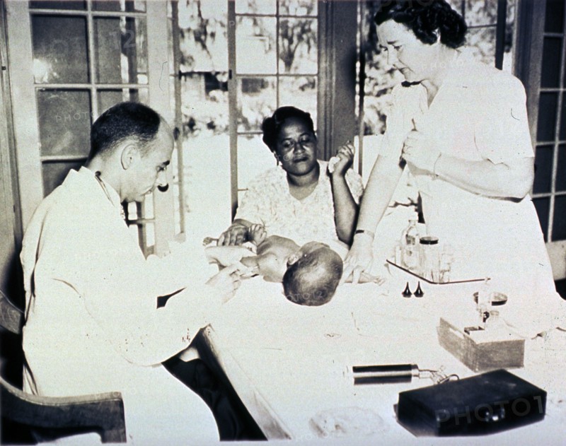 African American infant is getting an injection