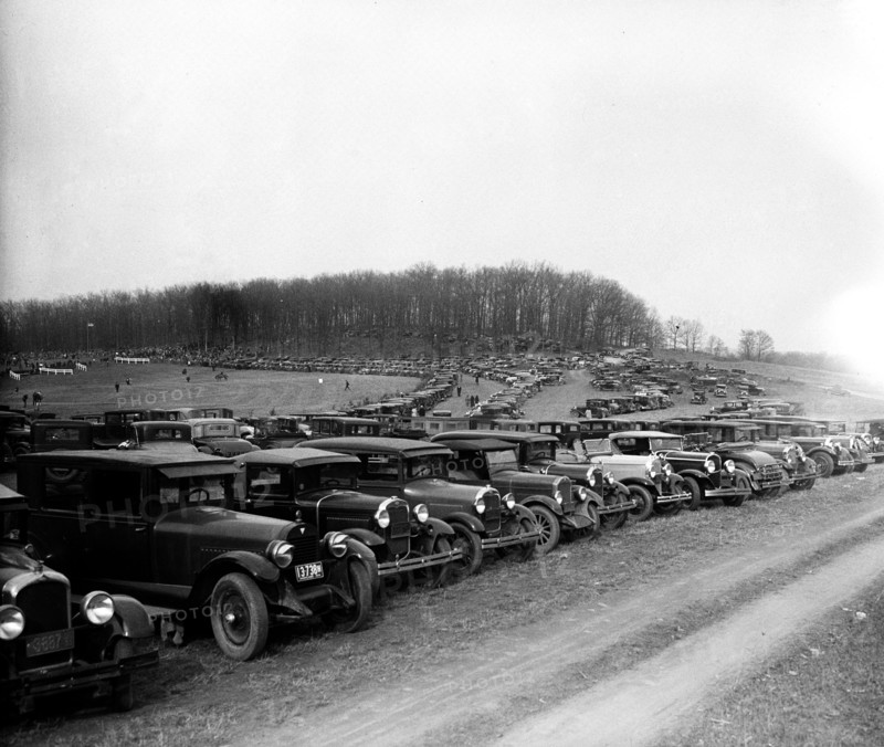Automobiles parked in field