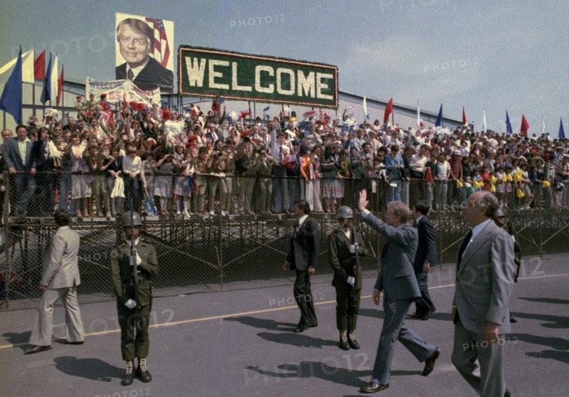 Jimmy Carter and Lopez Portillo wave during arrival ceremony for state visit to Mexico.