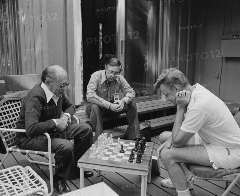 Menachem Begin and Zbigniew Brzezinski play chess at Camp David.