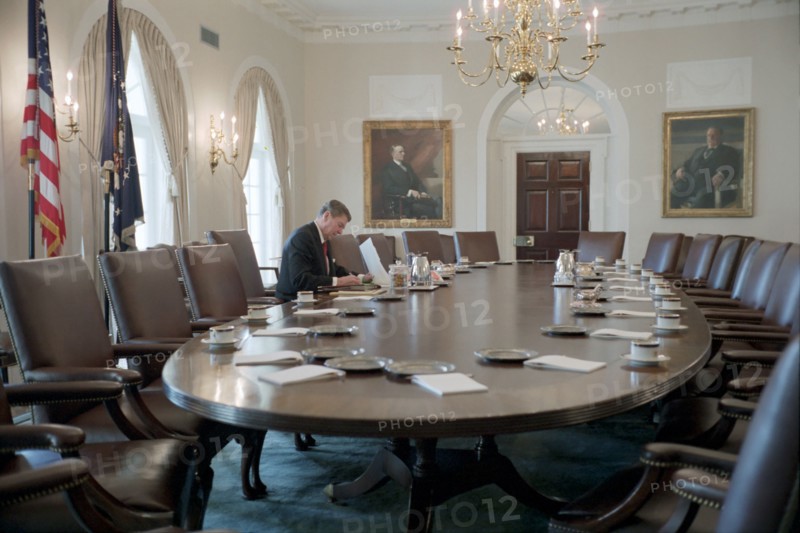 President Reagan working in the White House Cabinet Room.