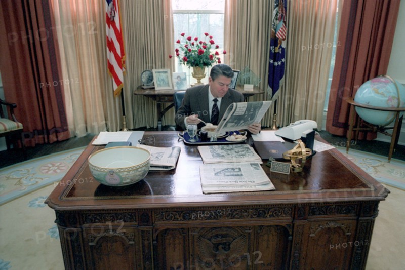 President Reagan eating lunch at his desk in the oval office