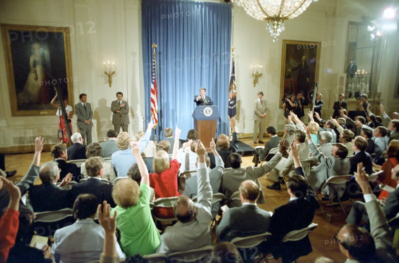 President Reagan listening to questions during a press conference.