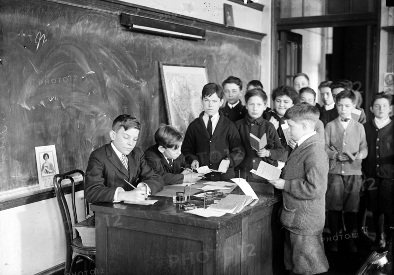 Children in classroom with chalkboard ca. 1915
