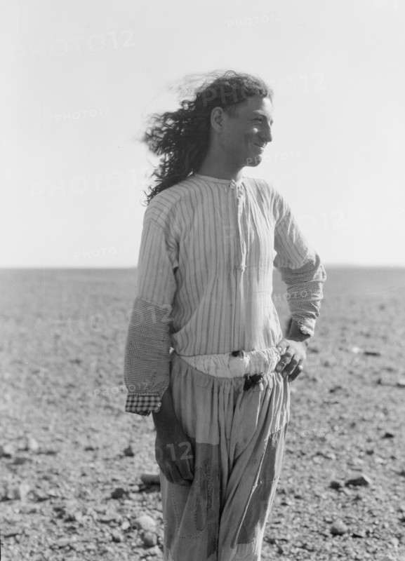 Bedouin life in Trans-Jordan, a bedouin road bulder with long hair in Trans-Jordan ca. 1920