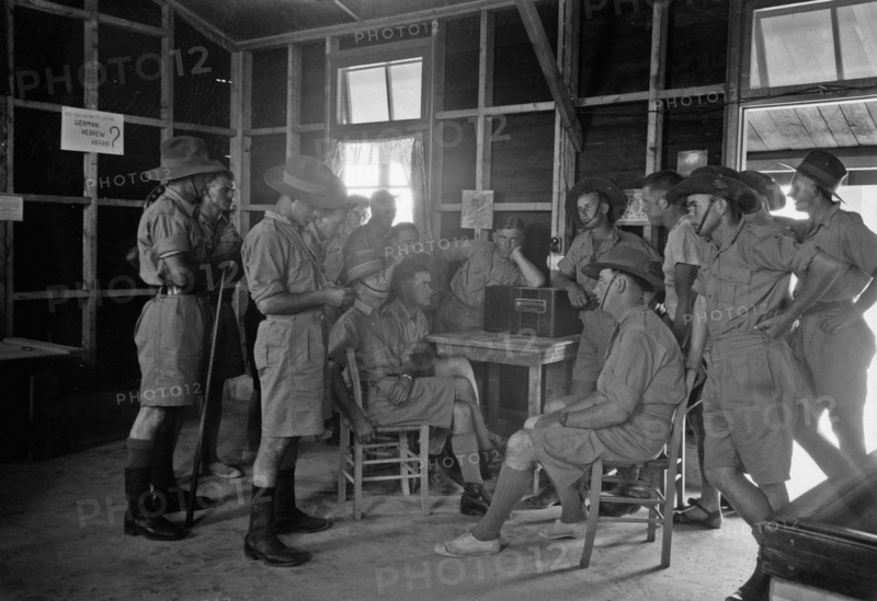Australian Army Y.M.C.A. in Julis Camp. Group of Australian soldiers listening to the radio ca. between 1940 and 1946
