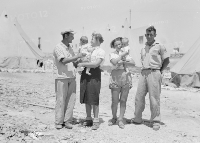 Maalek Hachamisha (Ma'ale HaHamisha) Kibbutz. Group of colonials, immigrants, holding babies ca. 1939