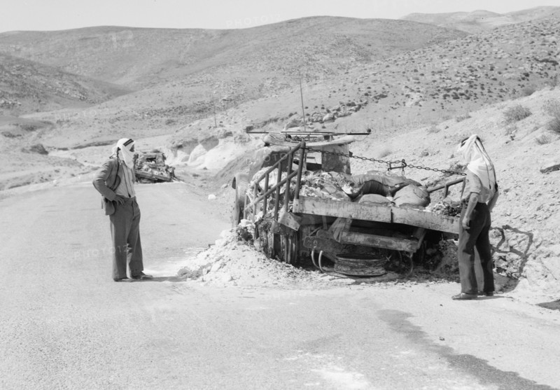 Men observing damage to Palestine Potash lorries burned down on the Jericho road ca. between 1934 and 1939