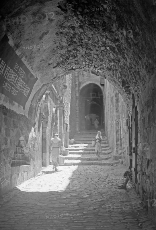 House of Veronica on Via Dolorosa 6th station of the Cross, people walking down the street ca. between 1940 and 1946