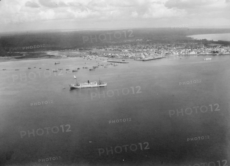 Aerial view of Zanzibar with the H.M.S. Pegasus seen in the port ca. 1936