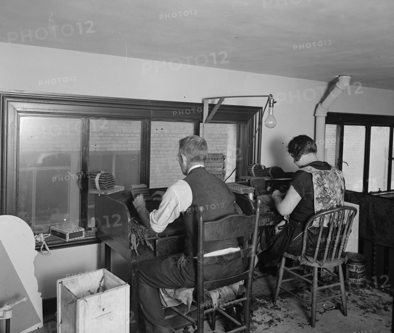Man and woman cigar rolling ca.  between 1910 and 1926