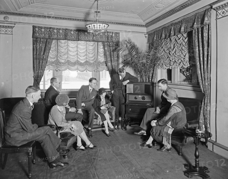 Thomas R. Shipp Company group listening to a radio in a room at the Hamilton Hotel ca. between 1910 and 1935
