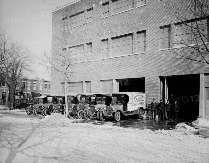 Parked Chestnut Farm Dairy trucks ca.  between 1910 and 1925