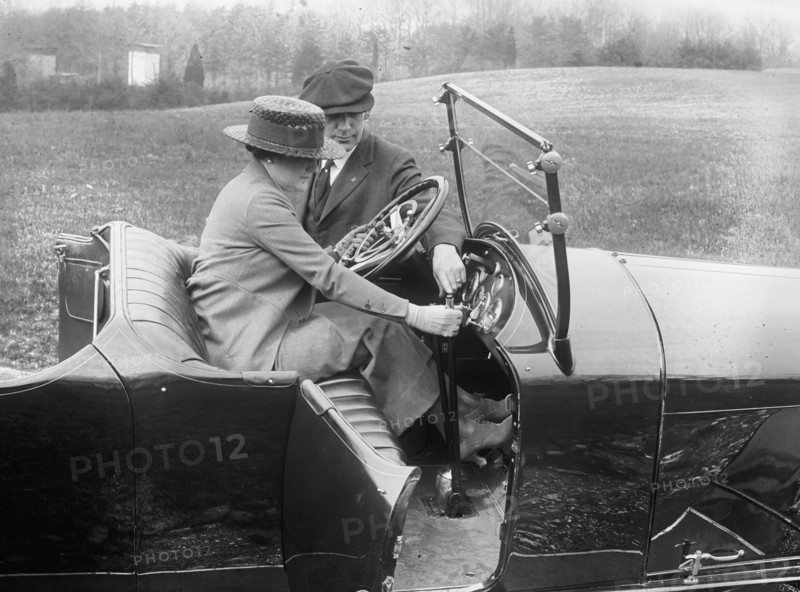 Woman instructed in driving an automobile ca.  between 1910 and 1920