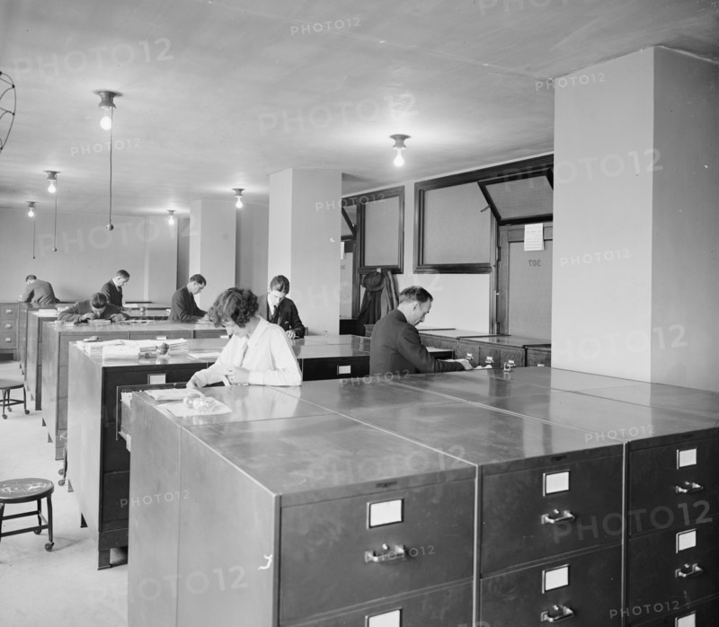 Workers looking through files at the Bureau of Identification ca.  between 1910 and 1926