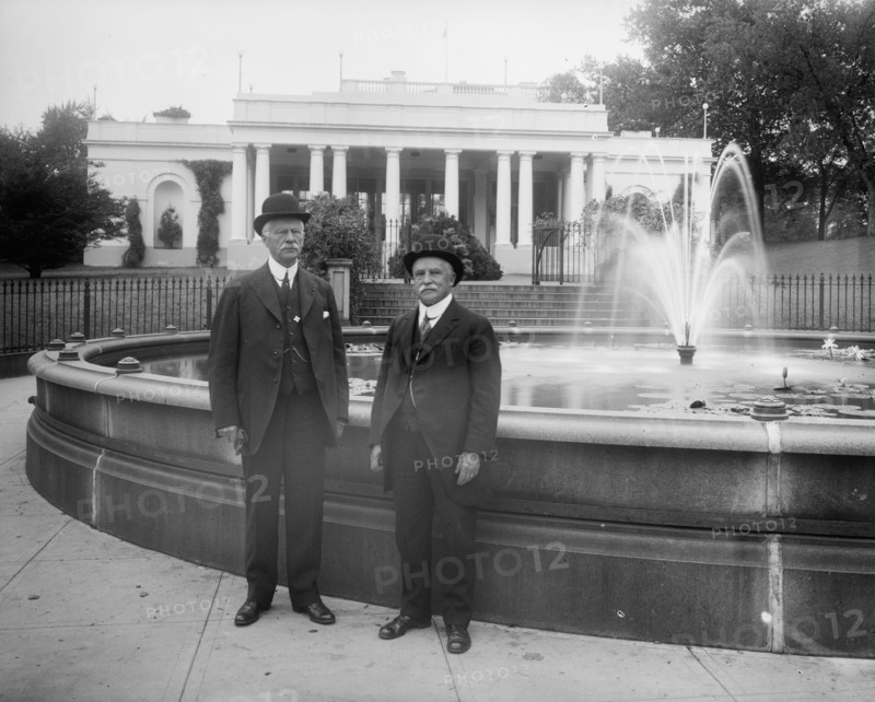 Thomas H. Fearey & Charles DeMitt Marcey standing next to a water fountain ca.  between 1910 and 1926