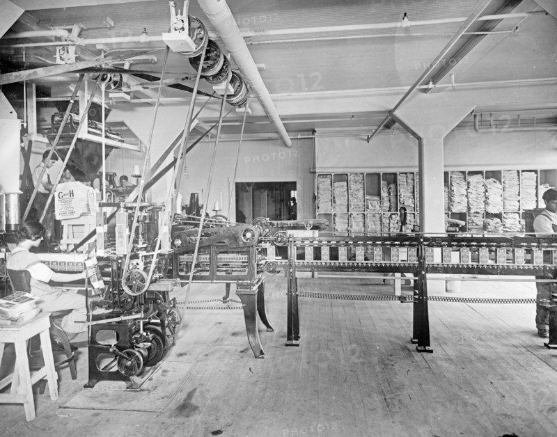 Carton Machine at the C&H Sugar factory. This machine folds, glues, fills, weighs and seals 30 2 lb. or 5 lb. cartons per minute with one operative ca.  between 1910 and 1920