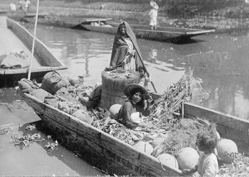 Women and a child on a boat in the MexiCompany Canal, Mexico City ca.  between 1909 and 1920